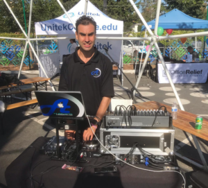 DJ Alex providing his services during an outdoor event.