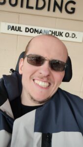 Photo of Damian smiling.